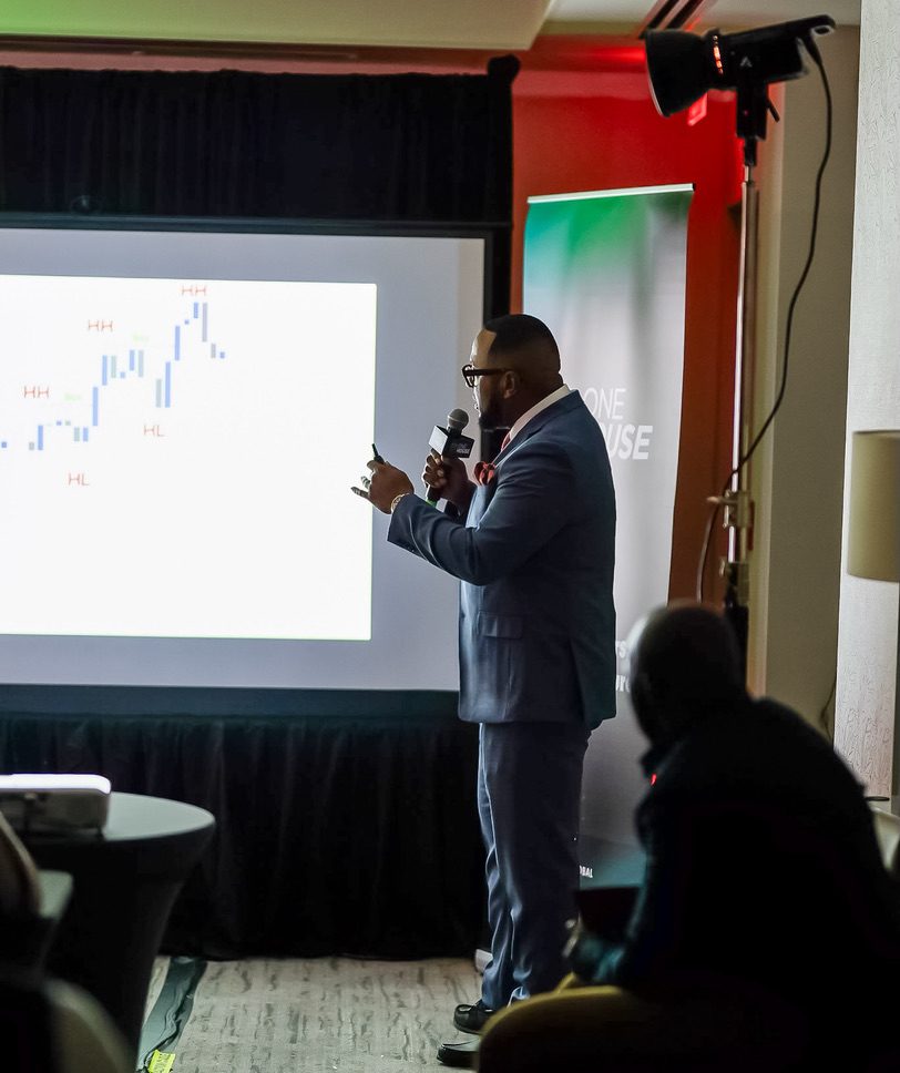 Richard Hall Jr. teaching market structure from a chart on a projector screen